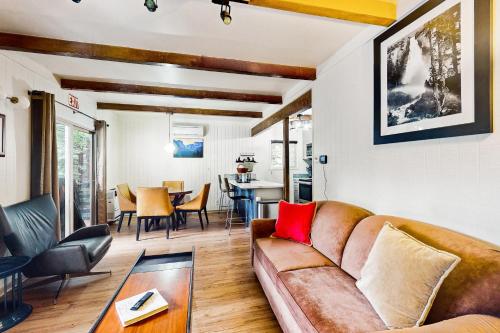 a living room with a couch and a table at Whispering Trees in Fish Camp