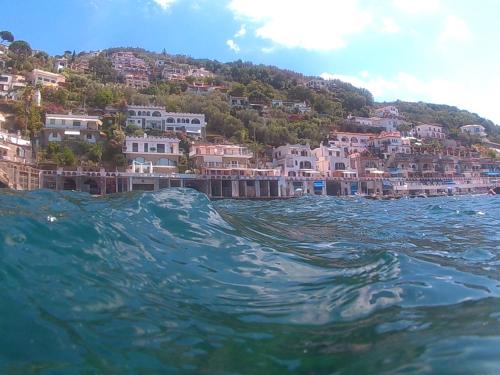 a view of a town from the water with houses at Bilocale panoramico “Lo sguardo” in Massa Lubrense