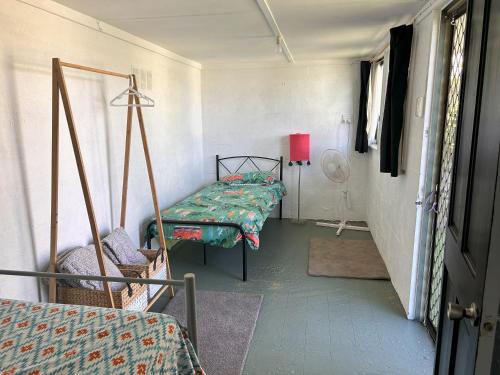 a hospital room with two beds and a window at Camelot in Yamba