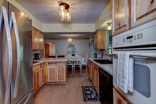 a kitchen with wooden cabinets and white appliances at The Water Lily Lodge in Inverness