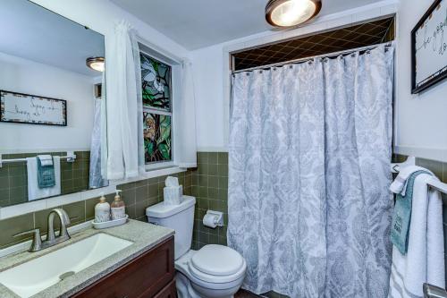a bathroom with a toilet and a sink and a window at The Water Lily Lodge in Inverness