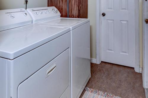 a white laundry room with a washer and dryer at The Water Lily Lodge in Inverness