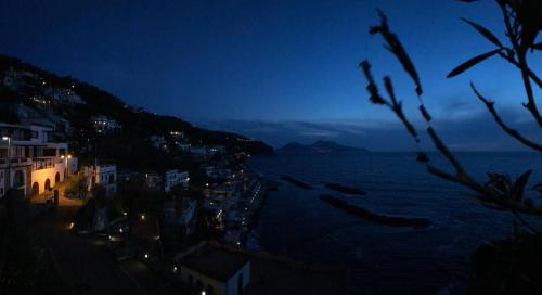 a view of the ocean at night at Bilocale panoramico “Lo sguardo” in Massa Lubrense