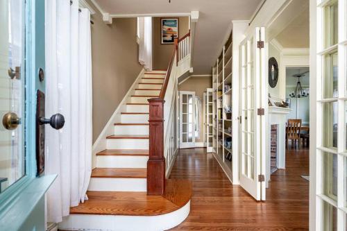 a hallway with a staircase in a home with a stair case at Stylish Victorian in Historic District in Cambridge