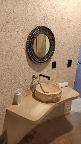 a bathroom with a sink and a mirror on a counter at Xùva in Mérida