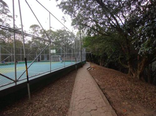 a tennis court with a net on a court at Apartamento en el cerro la Asomadera in Medellín
