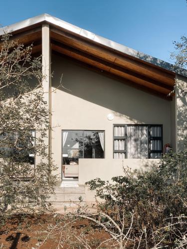 a house with a large window on the side of it at Umkhaya lodge in Mkuze