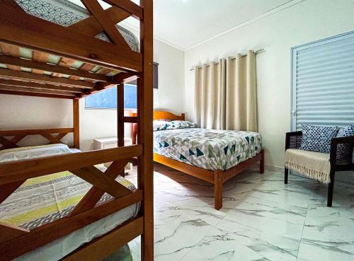 Ένα ή περισσότερα κρεβάτια σε δωμάτιο στο Casa c otima localizacao e Wi-Fi em Bertioga SP