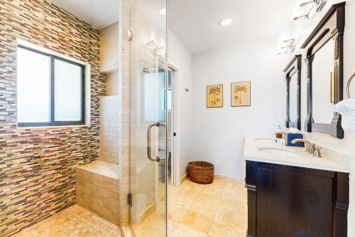 a bathroom with a glass shower and a sink at The Colorful Cabana in Key Largo