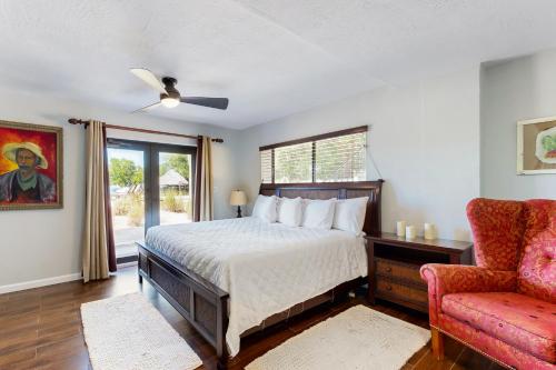een slaapkamer met een bed, een stoel en een raam bij The Colorful Cabana in Key Largo