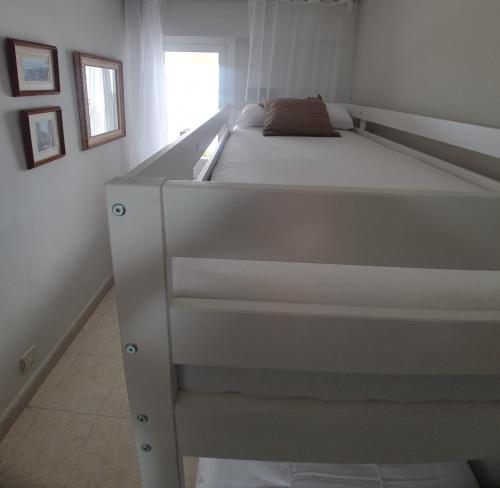 a large white bed in a white room at Beach front room NOT A HOTEL in Castelldefels