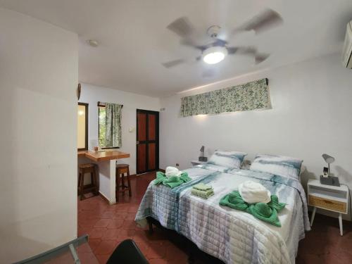a bedroom with a bed with towels on it at Villas Pura Vibra in Potrero