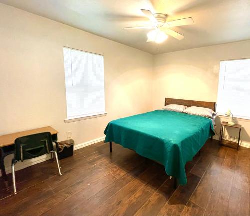 a bedroom with a bed and a ceiling fan at Private Room near downtown Dallas42 in Dallas