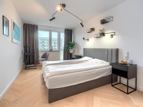 a bedroom with a large bed and a desk at Seaside Retreat Gdańsk - 64m2, Parking, Workspace- by Rentujemy in Gdańsk