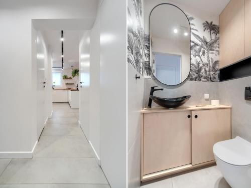 a bathroom with a sink and a mirror at Seaside Retreat Gdańsk - 64m2, Parking, Workspace- by Rentujemy in Gdańsk