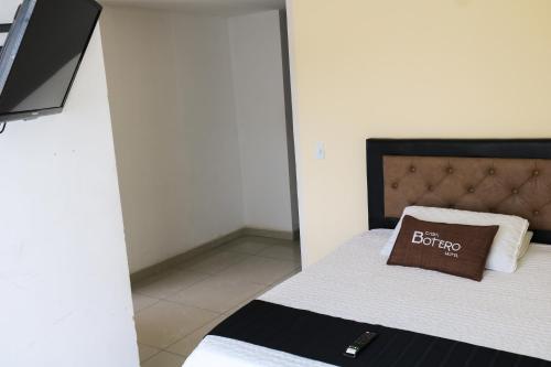 a bedroom with a bed with a pillow on it at Hotel Casa Botero 301 in Bogotá