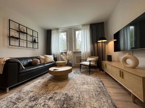 TV a/nebo společenská místnost v ubytování CityAppartLuxe am Hofgarten - zwischen Uni und Stadt-Zentrum