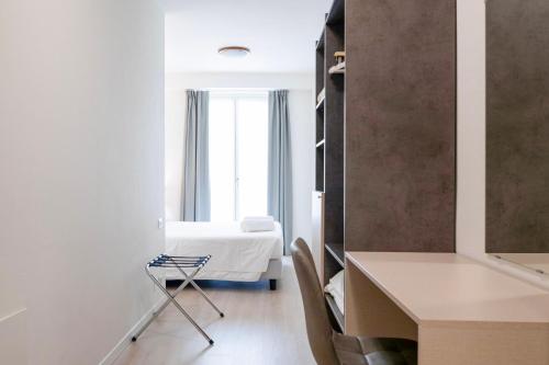 a white room with a bed and a window at Hotel dell'Angelo in Predore