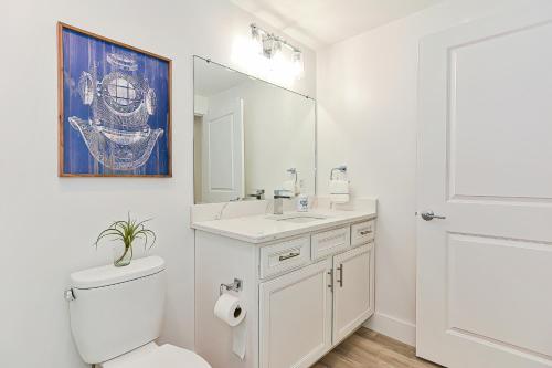 a bathroom with a toilet and a sink and a mirror at Harbourtown Suites, Unit 216 in Plymouth