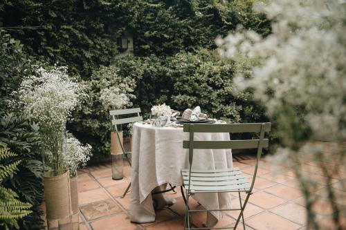 a table with a white table cloth and flowers on it at Nima Local House Hotel & Spa in Mexico City