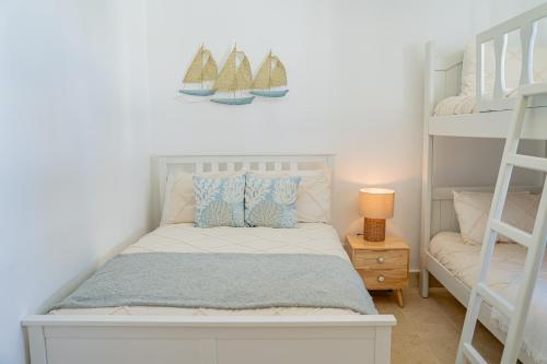 a bedroom with a bed with two bunk beds at Xeliter Green One Playa Dorada in San Felipe de Puerto Plata