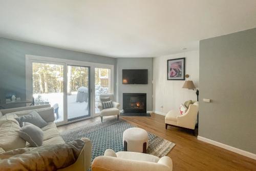 a living room with a couch and a fireplace at Waterville Vacation Condo in Waterville Valley