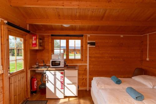 Postel nebo postele na pokoji v ubytování Gladheimar Cottages