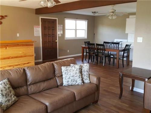 a living room with a couch and a dining room at Beach House Sleep 20 with VIP pkg, Bachelor Parties Welcomed in Lake Ozark