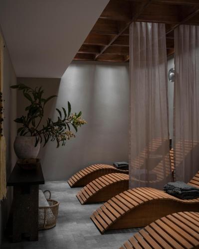 a room with two beds and a vase on the wall at Nima Local House Hotel & Spa in Mexico City