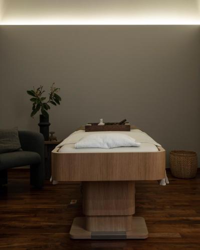 a wooden table with a bed on top of it at Nima Local House Hotel & Spa in Mexico City