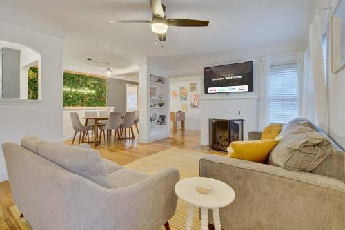 a living room with a couch and a tv at Sheridan Wildflower Downtown Family Fun w Firepit in Colorado Springs