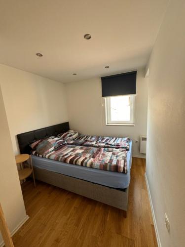 a bedroom with a bed and a window at Urban Haven Sarajevo in Sarajevo