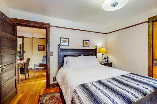 a bedroom with a large bed with a wooden headboard at St. Helens House in Bend