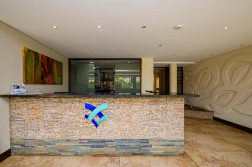 a lobby with a counter with a blue sign on it at Taarifa Suites by Dunhill Serviced Apartments in Nairobi