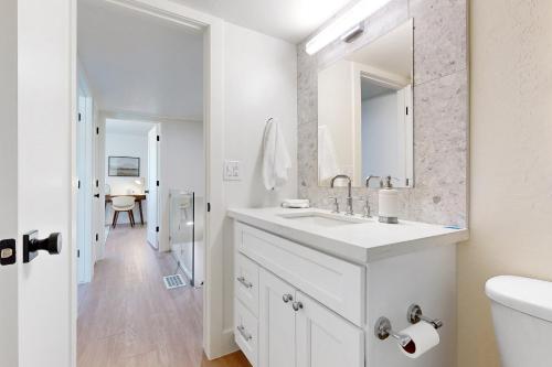 a white bathroom with a sink and a mirror at Scottsdale's Sanctuary in Scottsdale