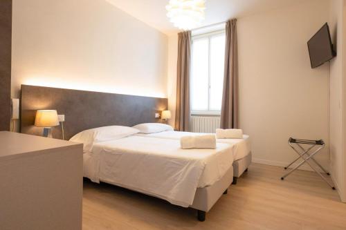 a bedroom with two beds and a large window at Hotel dell'Angelo in Predore