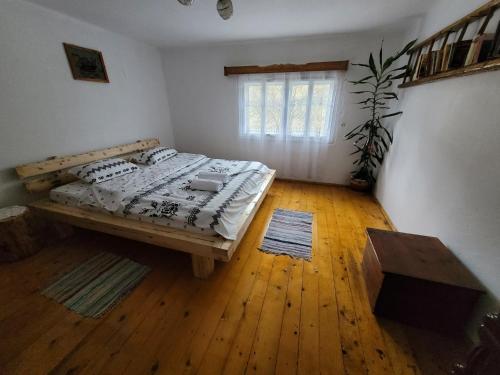 a bedroom with a bed and a wooden floor at Casa Izvorul Rece in Cîmpeni