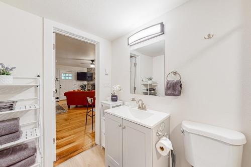 a white bathroom with a sink and a mirror at Wy'East Rest in Welches