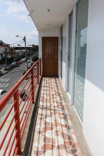 a walkway leading to a door on a building at Hotel Casa Botero 305 in Bogotá