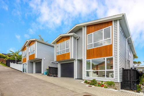 an apartment building with an orange and white at 123B Forresthill Rd in Auckland