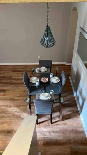a living room with a table and chairs and a chandelier at Vashay's Lovely vacation pad at Disney in Davenport
