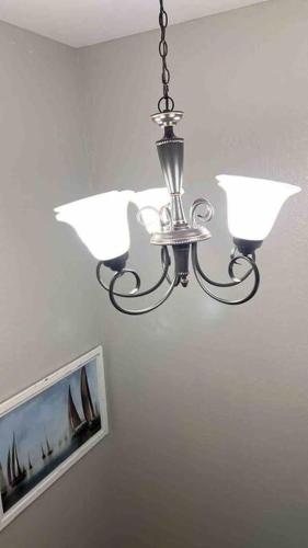 a chandelier hanging from a ceiling in a room at Vashay's Lovely vacation pad at Disney in Davenport