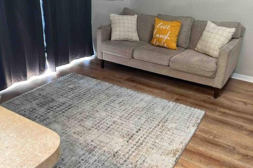 a living room with a couch and a rug at Vashay's Lovely vacation pad at Disney in Davenport
