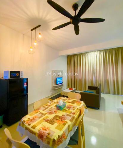 a living room with a table and a ceiling fan at Studio with Rooftop Pool at Youth City Nilai by D'KAY HOMES, near USIM KLIA in Nilai