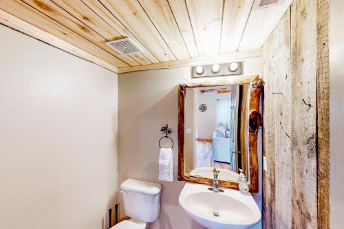a bathroom with a sink and a mirror at Ponderosa Pine Place in Flagstaff