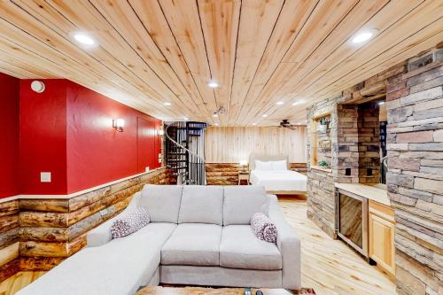 a living room with a couch and a red wall at Ponderosa Pine Place in Flagstaff