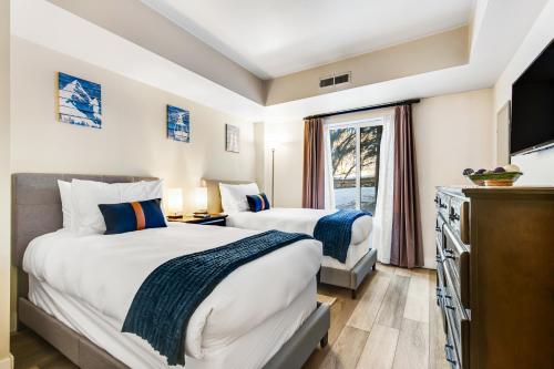 a hotel room with two beds and a window at Park Station #212 in Park City