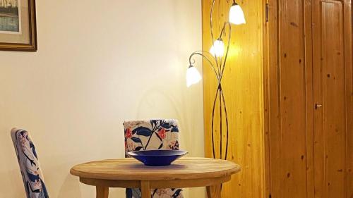 a table with a bowl on it with a lamp at Locanda Al Cacciatore in Nervesa della Battaglia