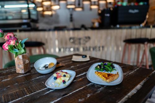 a wooden table with plates of food on it at HOTEL BOUTIQUE CASONA 65 in Puebla