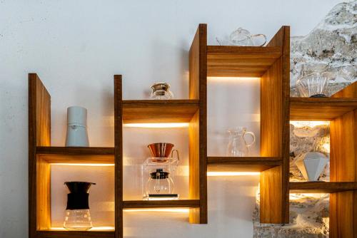 four wooden shelves with glass vases on them at HOTEL BOUTIQUE CASONA 65 in Puebla